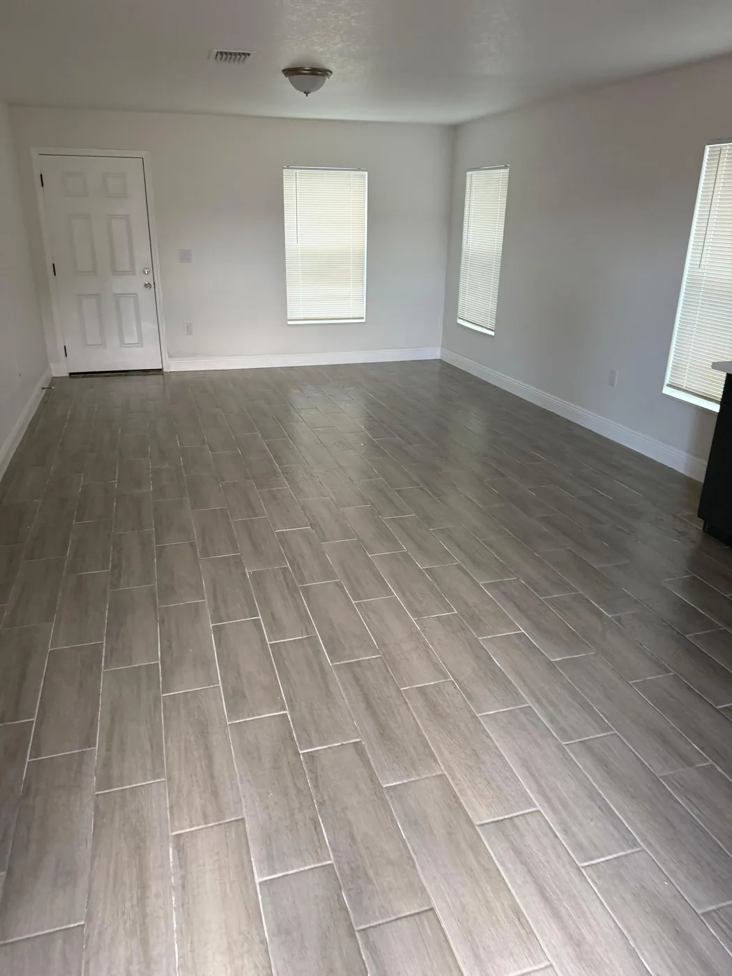 Wood-look tile floor through an open room