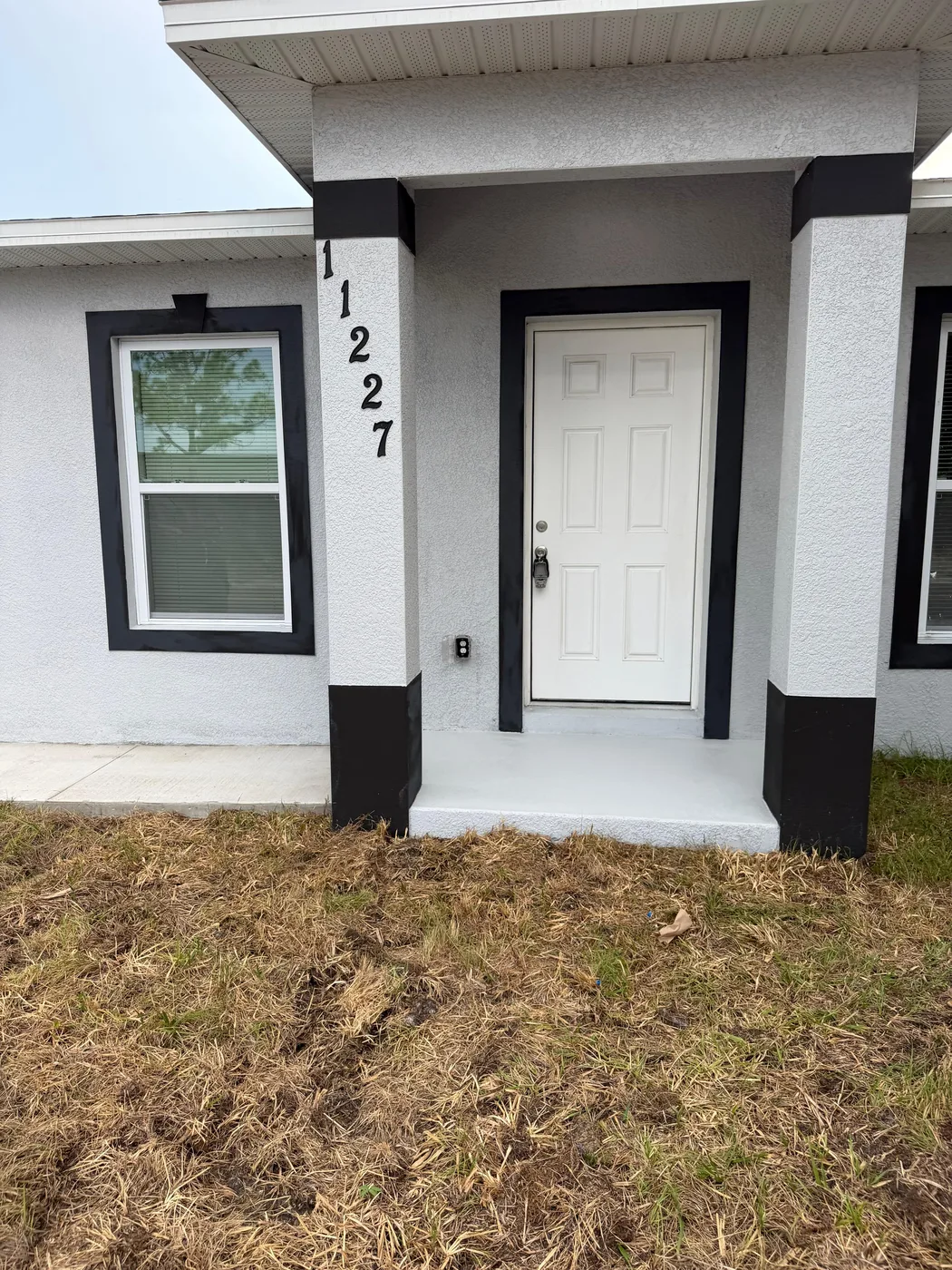 Remodeled home exterior in white with dark trim