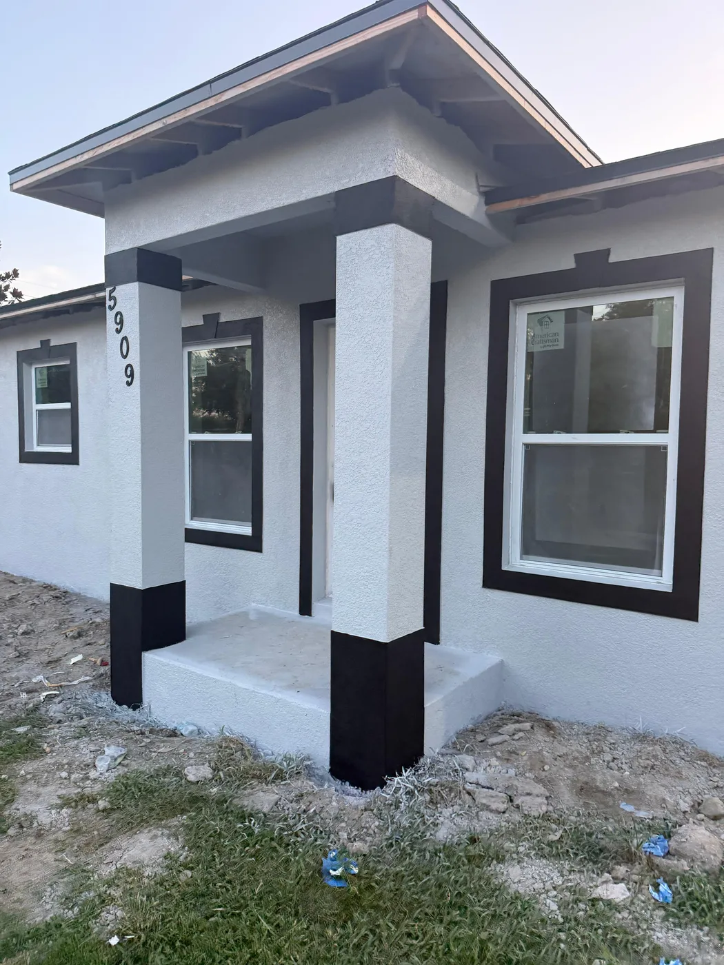 Freshly stuccoed and painted gray house