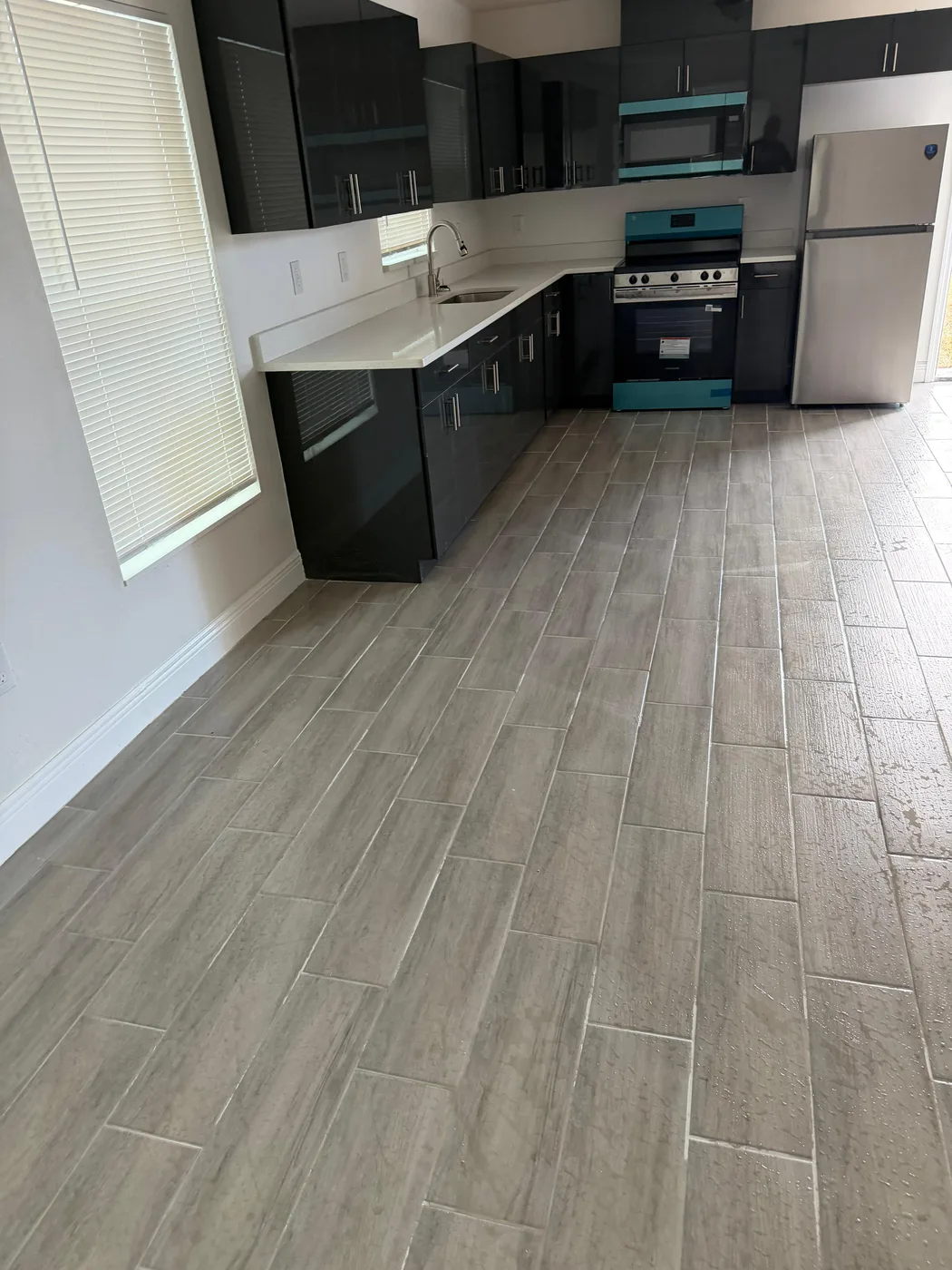 Kitchen remodel with dark cabinets and new floors